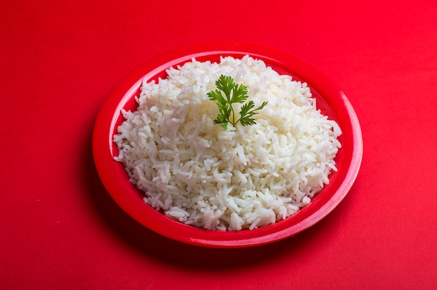 Cooked plain white basmati rice in a red plate