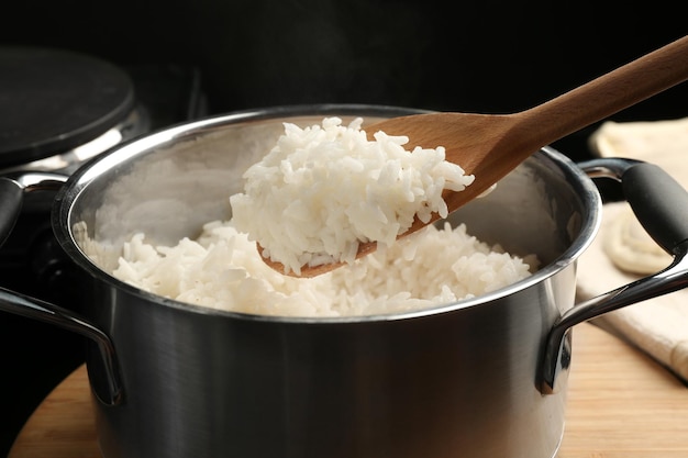 Cooked rice in metal saucepan closeup