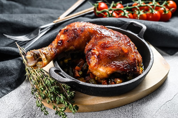 Cooked roasted chicken legs in baking pan. Grilled meat. Gray background. Top view