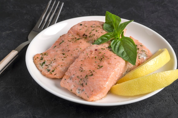 Cooked salmon with spices. on a white plate