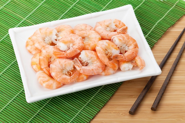 Cooked shrimps and chopsticks