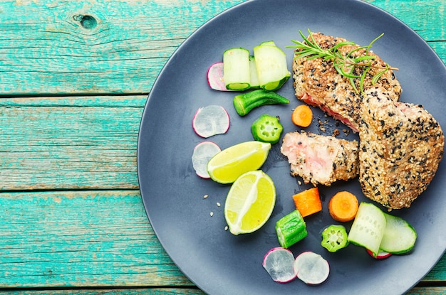 Cooked tuna steak in sesame with vegetables.Fish steak