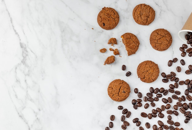 Cookies and coffee beans on granite table background with copy space for text, top view flat lay