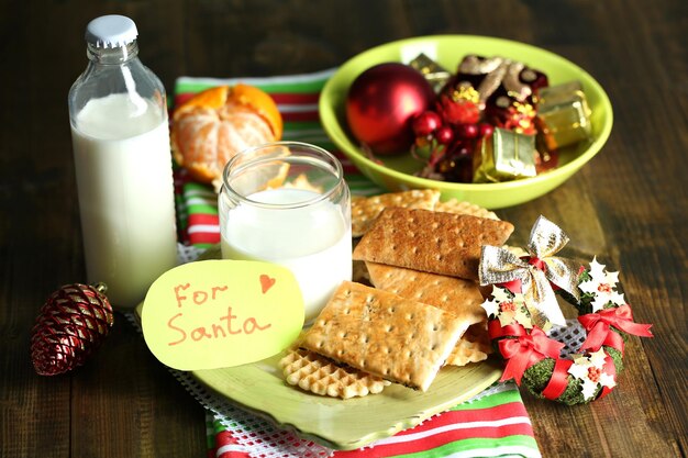 Cookies and milk for Santa. in wooden background