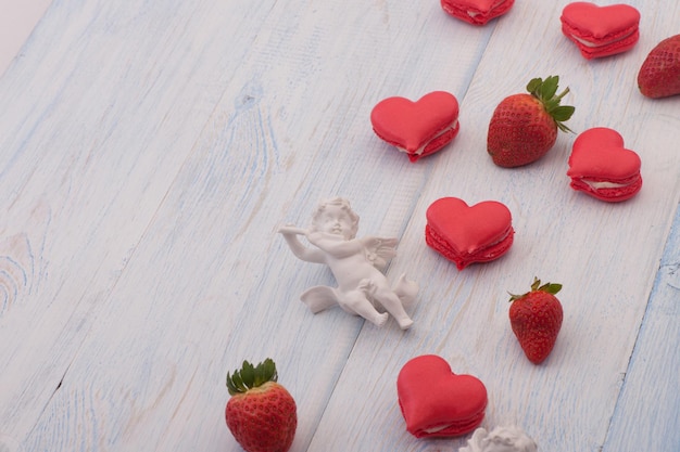 Cookies red heart shaped strawberries and decorated with angel Valentines Day