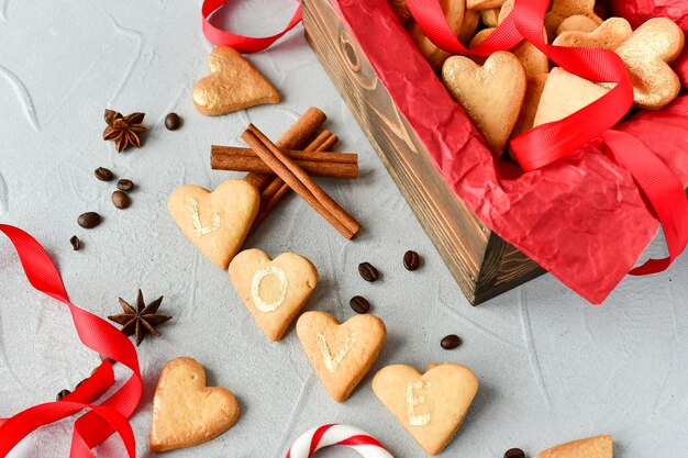 cookies in the shape of hearts, on cookies letters LOVE.decor red ribbons. happy Valentine's Day