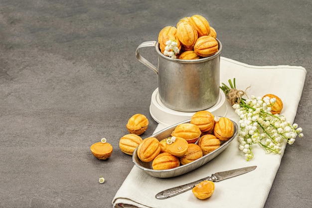 Cookies in the shape of walnuts with condensed milk cream fillingDelicious shortbread sandwiches