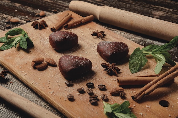 Cookies with mint in shape of heart on brown board gingerbread cookies cookie layout esthetics of ho