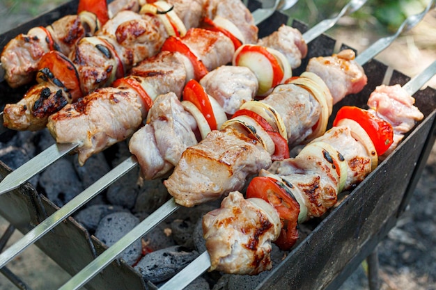 Cooking barbecue with vegetables on skewers Roasted meat on the grill closeup