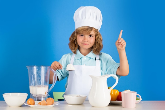 Cooking children chef kid boy making food with flour for healthy eat portrait of little child in for