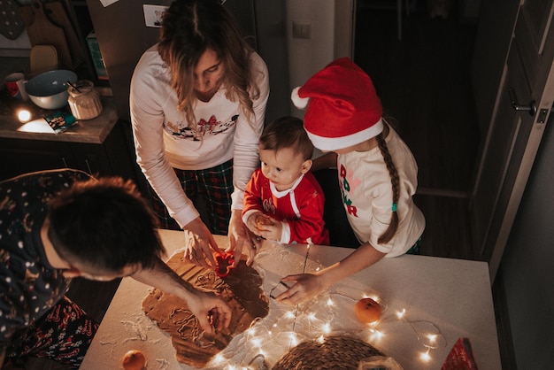 Cooking Christmas cookies with icing. Family