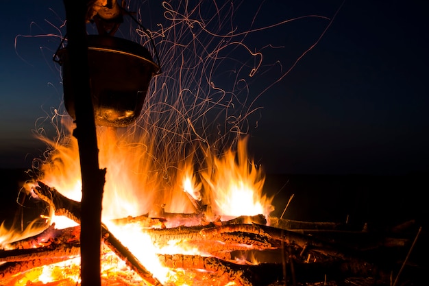 Cooking on the fire for a camping trip pot over a fire outdoors the romance of the wild tourism and ...