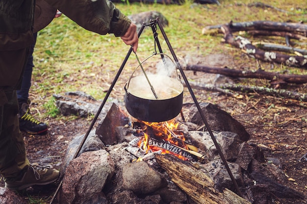 Cooking food on a fire in a pot