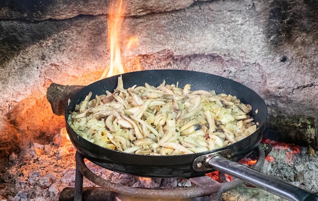 Cooking a fried onion and cayenne pepper with olive oil in a cast iron skillet