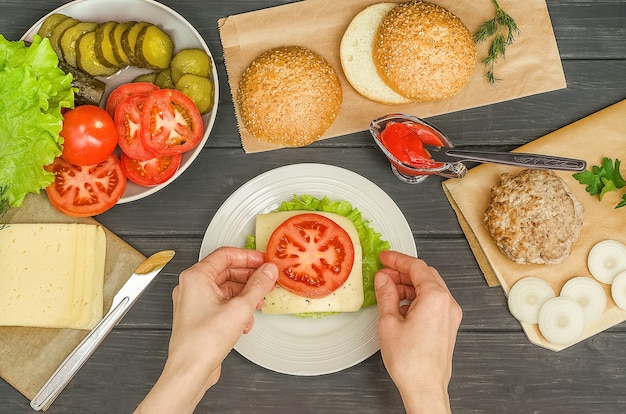 Cooking a hamburger step by step, step 7 - put a slice of tomato on the cheese