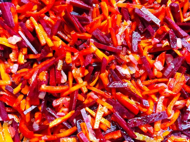 Cooking healthy food from vegetables Chopped carrots with beetroot in a frying pan