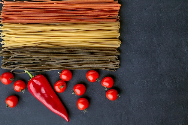 Cooking homemade pasta with natural tomatoes and paprika peppers