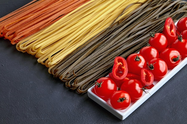 Cooking homemade pasta with natural tomatoes and paprika peppers