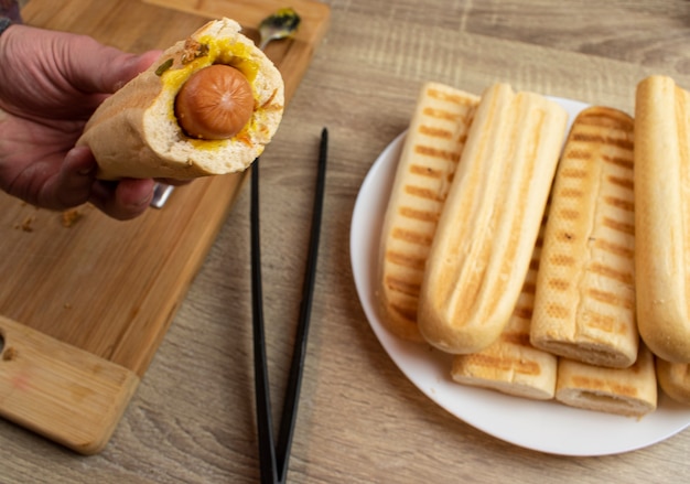 Cooking a hot dog at home on the grill, the whole process from toasting bread to folding a hot dog into one piece