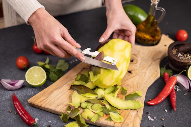 Cooking mango salsa woman peeling mango fruit