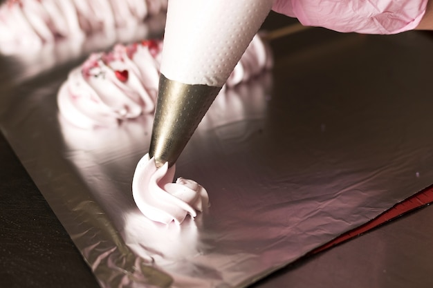 Cooking meringue on a stick, the process of making sweets from egg white