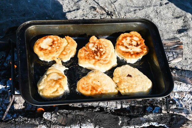 Cooking pancakes over the fire