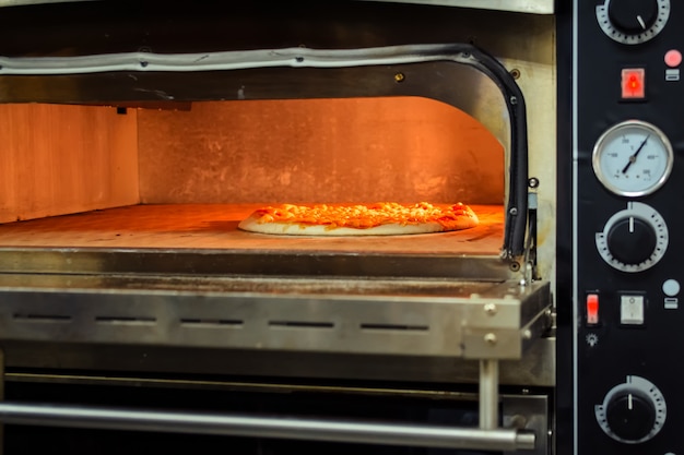 Photo cooking pizza in an electric oven