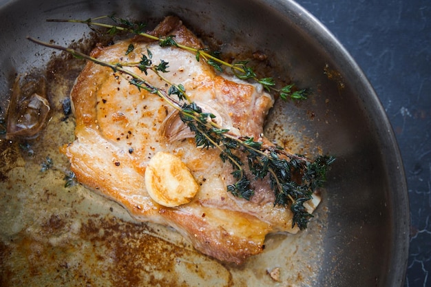 Cooking, Pork Steak with Thyme in a Metal Pan