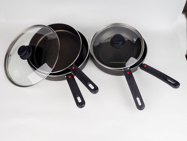 Photo cooking pot and frying pans on white surface