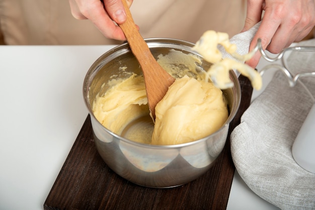 Cooking process profiteroles, puffs, eclaires. Cook prepares the dough.