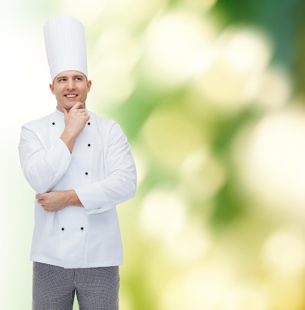 cooking, profession, inspiration and people concept - happy male chef cook thinking over green background