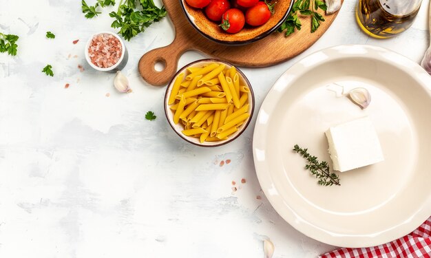 Cooking recipe ingredients Fetapasta with cherry tomatoes, feta cheese, garlic and thyme