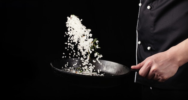 Cooking roasted aromatic salt in a pan by chef hand. 