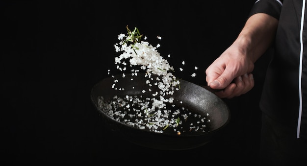 Cooking roasted aromatic salt in a pan.