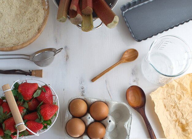 Cooking scene , kitchen utensils and ingredients for pie, top view