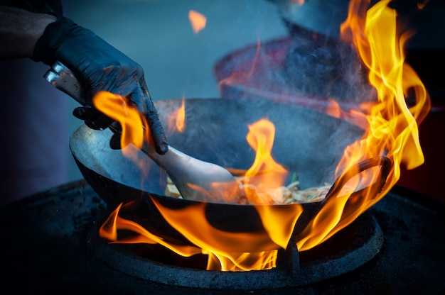 Cooking street food on a hot frying pan