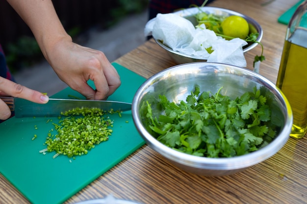 cooking in the summer kitchen slicing onions on a cutting board