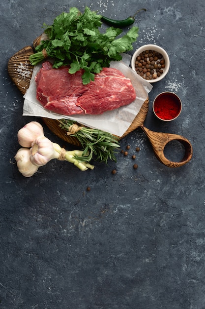 Cooking table with beef meat, vegetables, spices and herbs. Food menu 