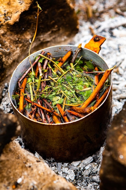 Cooking tea drink at fire in wild