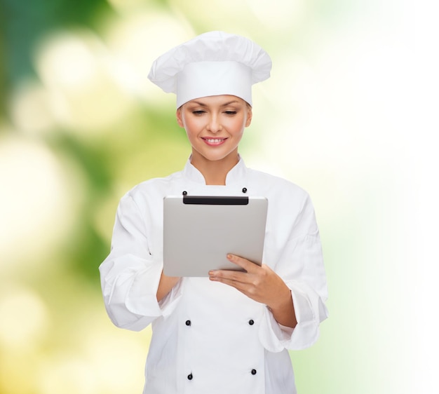 cooking, technology and food concept - smiling female chef, cook or baker with tablet pc computer