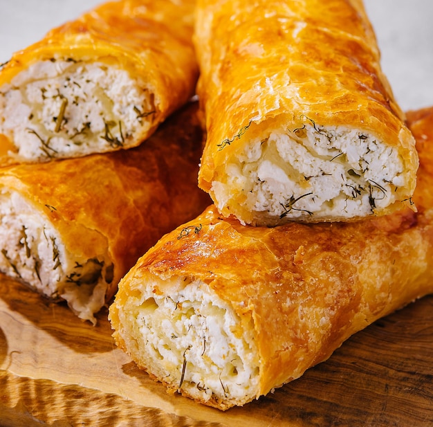 Cooking traditional pies with cottage cheese on wooden table