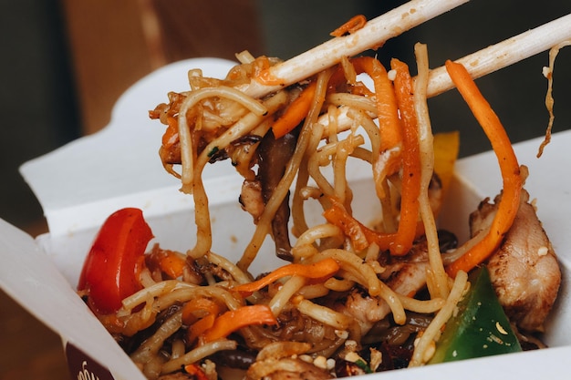 Cooking udon noodles with various additives to take away