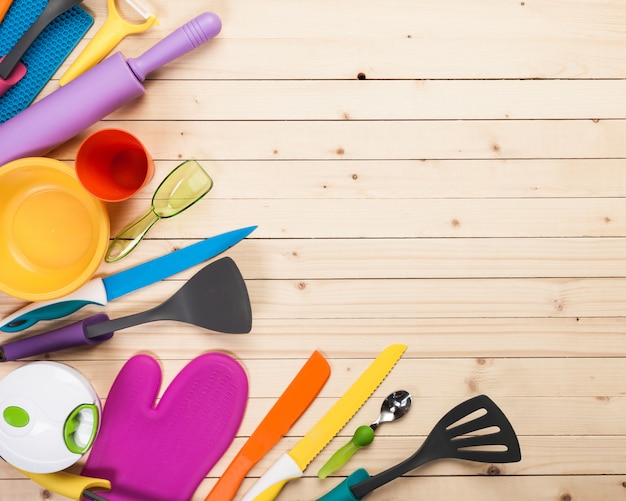 Cookware and accessories on a wooden table.