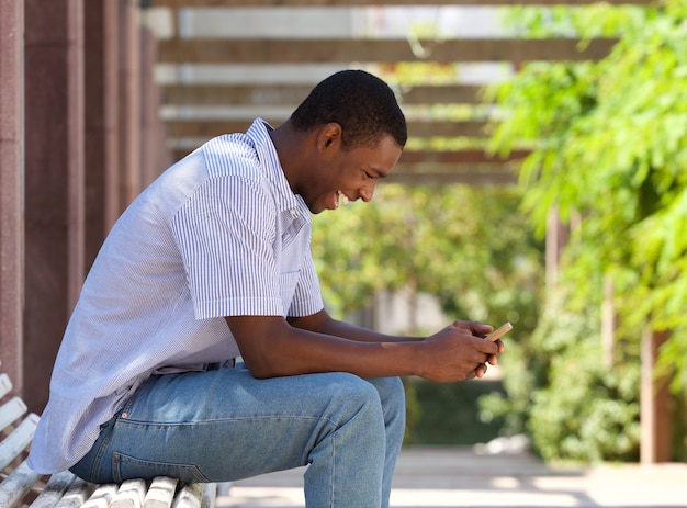 Cool african american guy looking at cell phone 