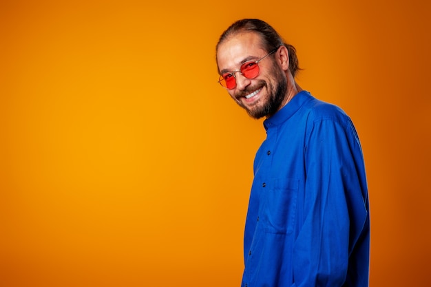 Cool long haired joyful man wearing glasses close up