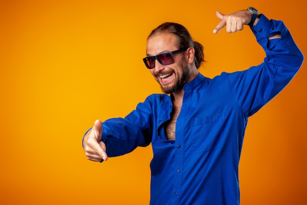 Cool long haired joyful man wearing glasses