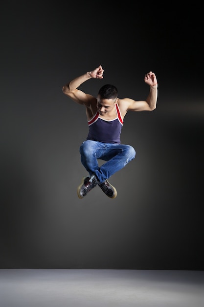 Cool looking dancer posing in front of the studio background