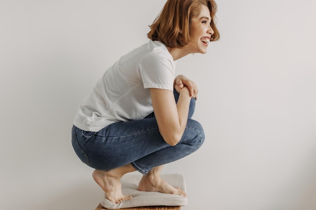 Cool looks woman in white tshirt and jean relax in her apartment room