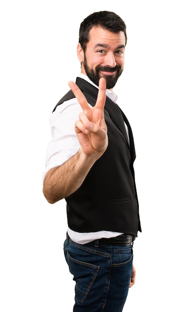 Cool man making victory gesture on isolated white background