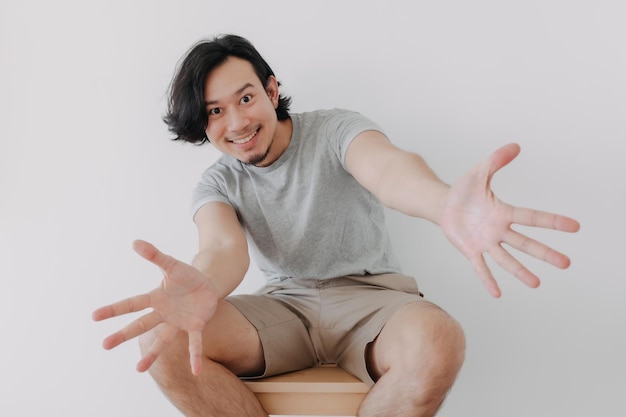 Cool man sitting on the chair and presenting for advertising